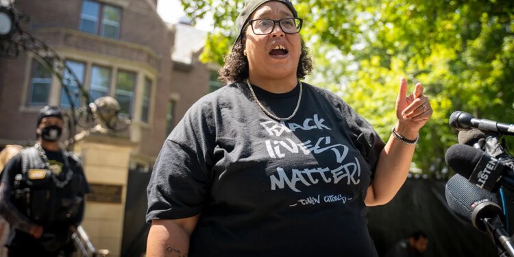 BLM leader in black shirt at outside rally
