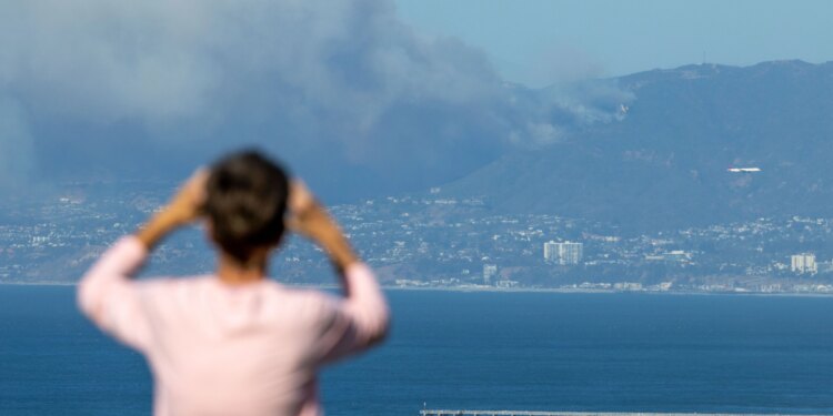 A fast-moving fire fueled by heavy winds and brush moved...