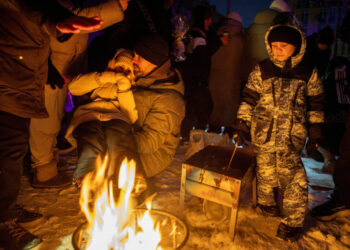 FILE PHOTO: Locals dance the cold away at a blackout party during electricity an outage in Kyiv