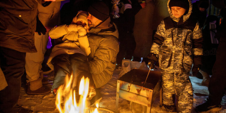 FILE PHOTO: Locals dance the cold away at a blackout party during electricity an outage in Kyiv