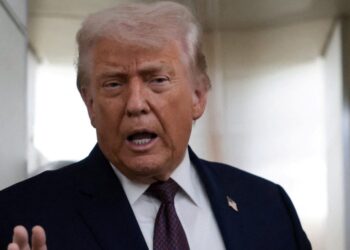 FILE PHOTO: U.S. President Donald Trump speaks to reporters aboard Air Force One