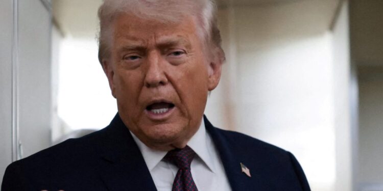 FILE PHOTO: U.S. President Donald Trump speaks to reporters aboard Air Force One