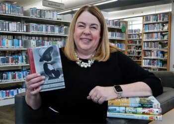 Julie Wendorf, director of the Crown Point Community Library and president of the Indiana Library Federation, discussed some of the books that have been challenged, including controversial titles stolen from the shelves and attempts to censor titles by legislation. Wendorf is shown at the Crown Point Community Library on Friday, Feb. 21, 2025. (John Smierciak / Post-Tribune)