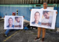 Family members of detainees wait outside the Helicoide detention centre, in Caracas