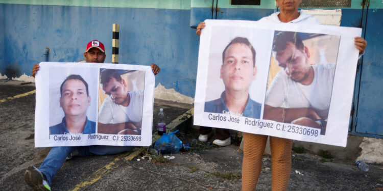 Family members of detainees wait outside the Helicoide detention centre, in Caracas