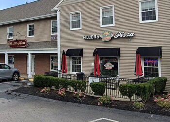 beige building with hillers pizza sign