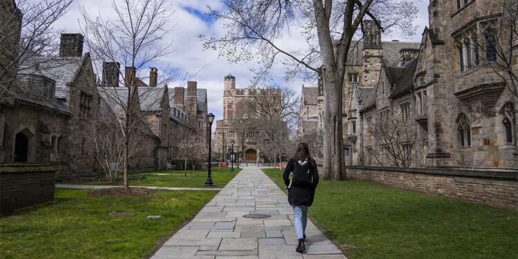 A Yale student walks through campus.