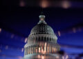 FILE PHOTO: The U.S. Capitol dome is seen reflected in a puddle in Washington