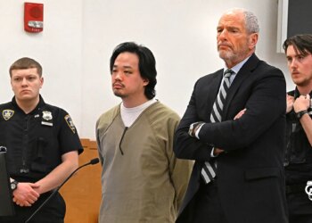 Jeopardy contestant Winston Nguyen standing in a courtroom with a visible bruise under his eye.