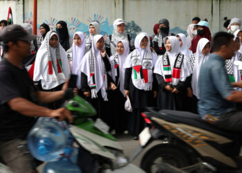 Women in solidarity with Palestinians take part in a protest outside the Palestinian Embassy in Jakarta