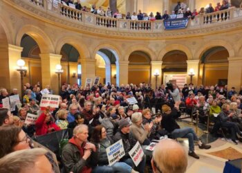 Hundreds of people attend a rally in the rotunda of the Minnesota State Capitol.