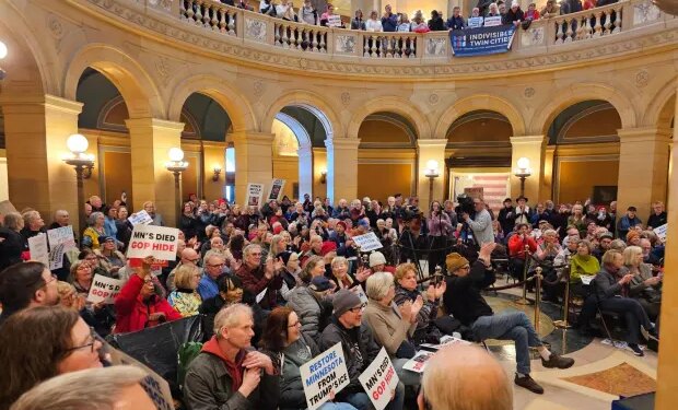 Hundreds of people attend a rally in the rotunda of the Minnesota State Capitol.
