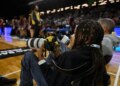 12-year-old Myles Minishotta works as a photographer at this week's Central Intercollegiate Athletic Association men's and women's basketball tournaments at CFG Bank Arena in Baltimore. (Kenneth K. Lam/Staff)
