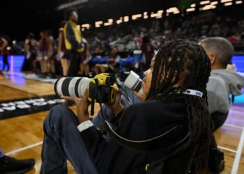 12-year-old Myles Minishotta works as a photographer at this week's Central Intercollegiate Athletic Association men's and women's basketball tournaments at CFG Bank Arena in Baltimore. (Kenneth K. Lam/Staff)
