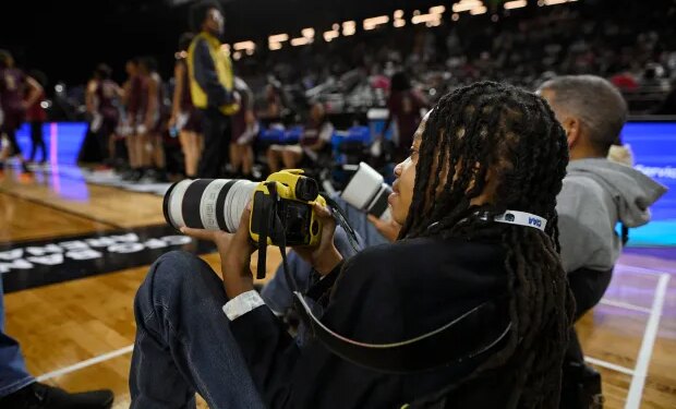 12-year-old Myles Minishotta works as a photographer at this week's Central Intercollegiate Athletic Association men's and women's basketball tournaments at CFG Bank Arena in Baltimore. (Kenneth K. Lam/Staff)
