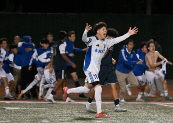 Bishop Amat players celebrate their 2-1 win against Newport Harbor...