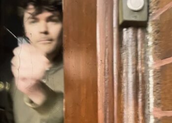 In a still from video, far-right streamer Nick Fuentes appears to pepper-spray Marla Rose out his door in Berwyn. (Marla Rose)