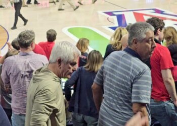 Chris Nanos leaving seat at basketball game