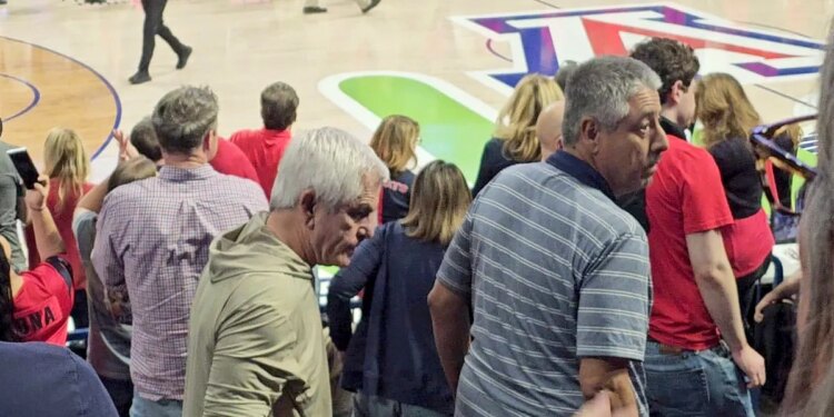 Chris Nanos leaving seat at basketball game