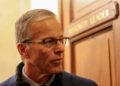 John Thune speaks with reporters following Senate votes regarding a dispute over immigration enforcement, and with a parti...