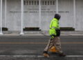 A worker walks in front of the recently renamed Donald J. Trump and John F. Kennedy Memorial Center for the Performing Art...