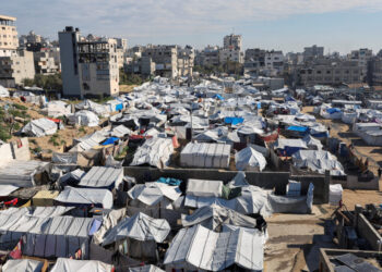 Palestinians displaced during the two-year Israeli offensive, shelter at a tent camp in Gaza City