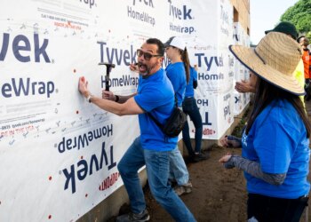 CJ Bibolet, with City National Bank, clowns around while working...