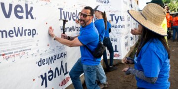 CJ Bibolet, with City National Bank, clowns around while working...