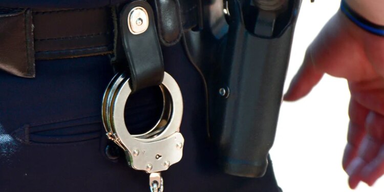 Handcuffs and gun on police belt