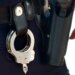 Handcuffs and gun on police belt