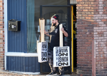 Man holding signs upside down