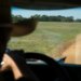 Bob Sanders steers his pickup along a dirt road on his East Texas ranch.