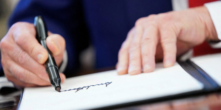 FILE PHOTO: U.S. President Donald Trump signs executive orders at the White House