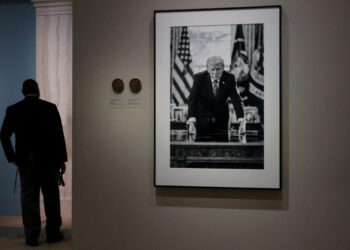 People view the portrait of U.S. President Donald Trump at the Smithsonian National Portrait Gallery in Washington