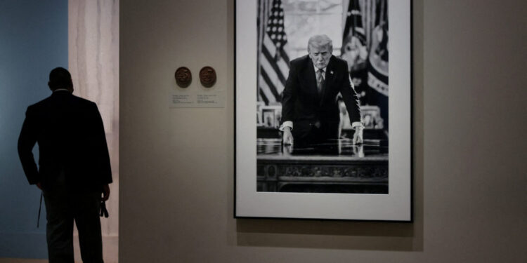 People view the portrait of U.S. President Donald Trump at the Smithsonian National Portrait Gallery in Washington