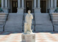 A statue of Christopher Columbus stands outside the Eisenhower Executive Office Building near the White House