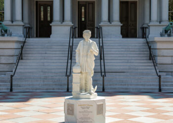 A statue of Christopher Columbus stands outside the Eisenhower Executive Office Building near the White House