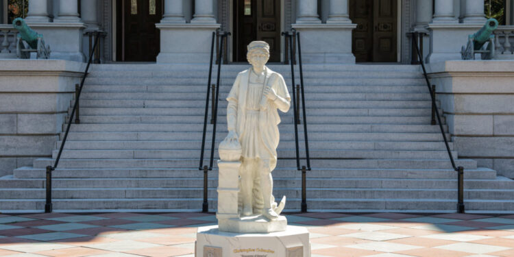 A statue of Christopher Columbus stands outside the Eisenhower Executive Office Building near the White House