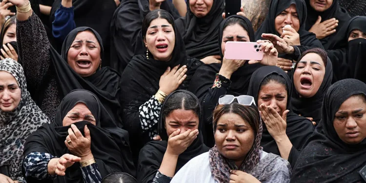 Mourners cry during a funeral for children killed in a reported strike on a primary school in Minab, Iran, on March 3, 2026.