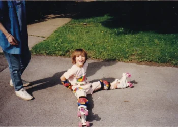 The author learning to roller skate as a child.