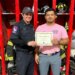 fire department honors Perez-Glass with certificate.
