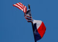 FILE PHOTO: The U.S flag and the Texas State flag fly over the Texas State Capitol in Austin