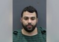 Hisham Abugharbieh in a booking photo facing forward against a height chart background