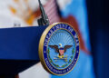 A seal for the Department of War on the podium at the Pentagon