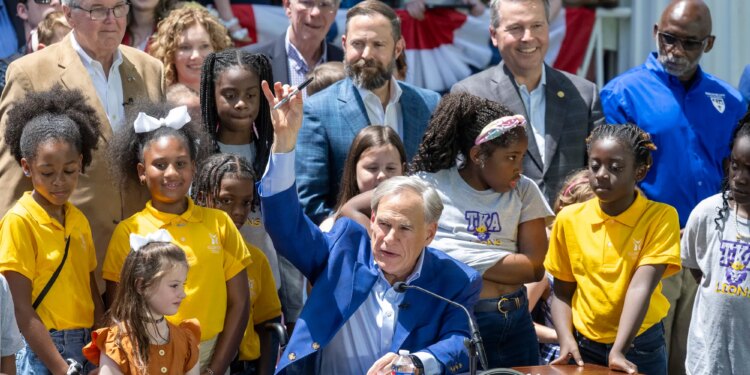 Gov. Greg Abbott signs SB2, the authorizing educational savings accounts (ESA's) to help parents pay private school tuition for their children during a ceremony at the Texas Governor's Mansion on May 3, 2025.