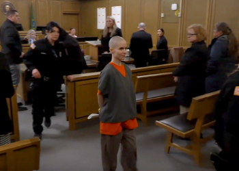 Alyssa Bradburn walks in court custody, smiling, during sentencing in Spokane murder case