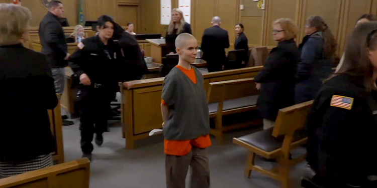 Alyssa Bradburn walks in court custody, smiling, during sentencing in Spokane murder case