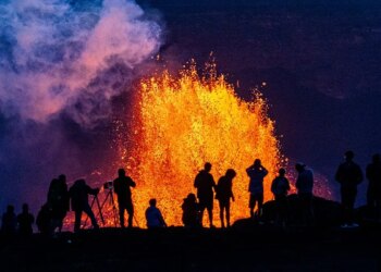 People watch as Hawaii's Kilauea Volcano erupts
