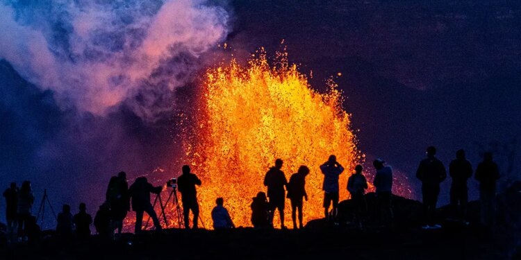 People watch as Hawaii's Kilauea Volcano erupts