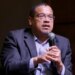 Minnesota Attorney General Keith Ellison speaking at a microphone indoors